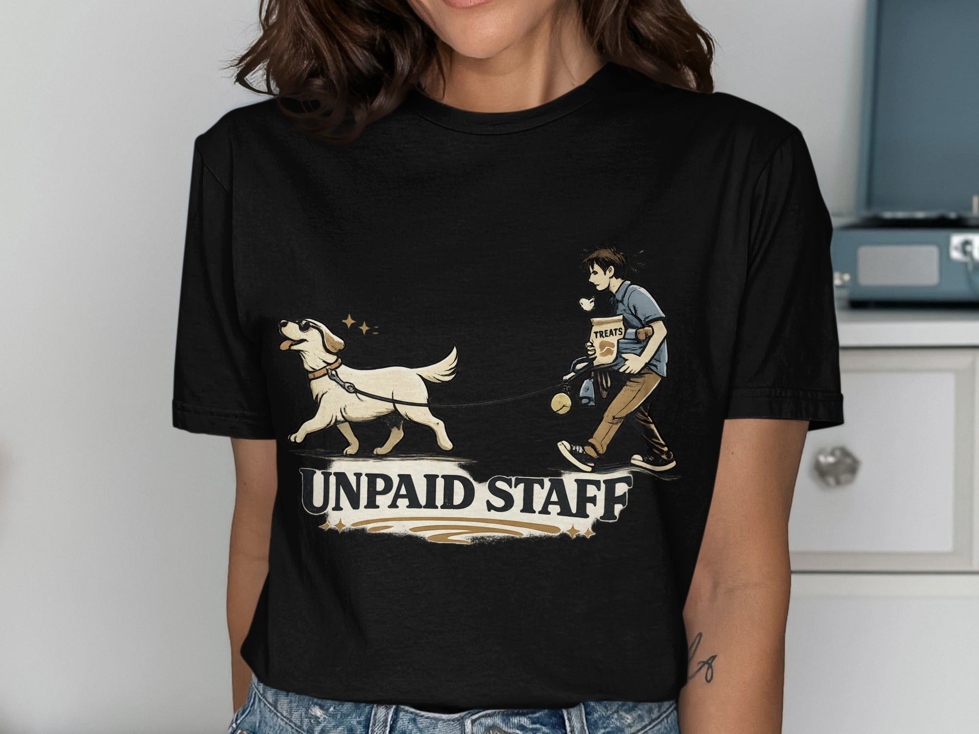 Black t-shirt with graphic of person walking dog, "UNPAID STAFF" text.