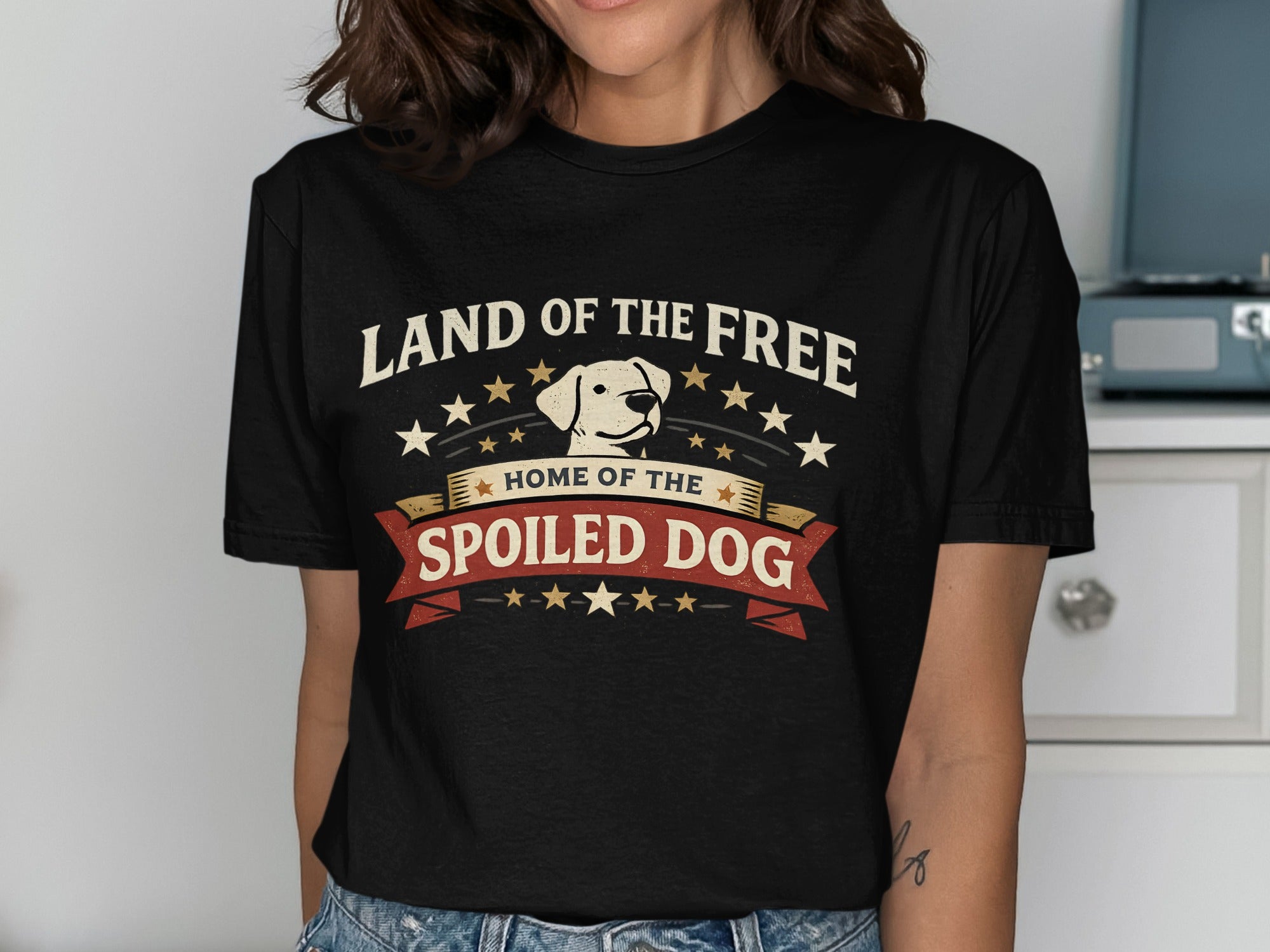 Black t-shirt with "Land of the Free, Home of the Spoiled Dog" and dog graphic.