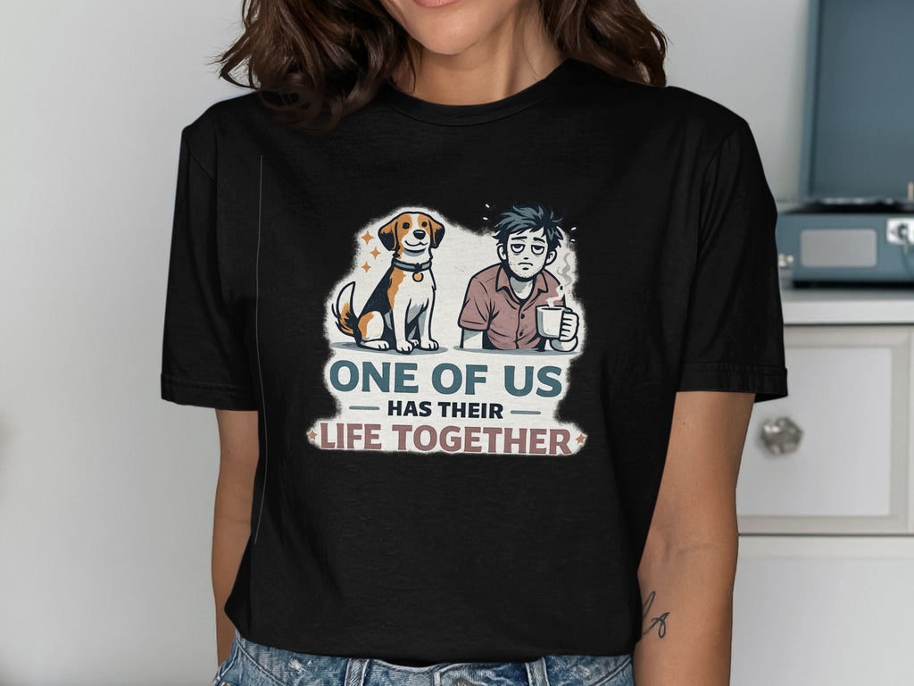 T-shirt graphic: dog and tired man with text "One of us has their life together".
