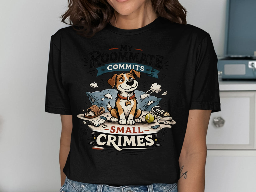 T-shirt graphic of a dog sitting on pillows with "MY ROOMMATE COMMITS SMALL CRIMES" text.