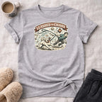 Leashed to Chaos graphic on a gray t-shirt with a dog and boy playing.