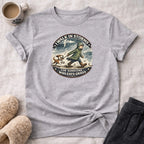 T-shirt with graphic of person walking dog in rain, text "I walk in storms for someone who eats grass."